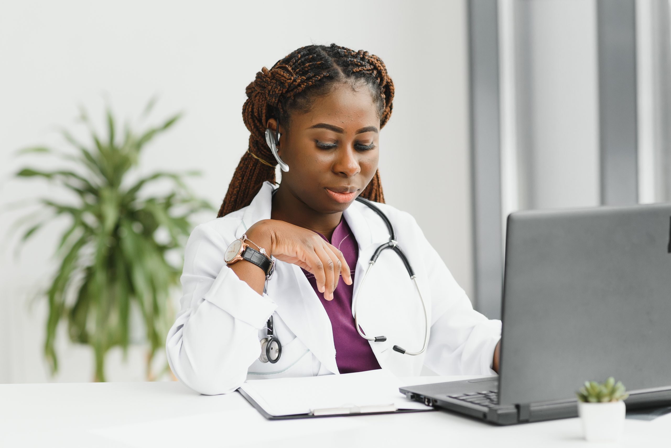 medicine, online service and healthcare concept - happy smiling african american female doctor or nurse with headset and laptop having conference or video call at hospital medicine, online service and healthcare concept - happy smiling african american female doctor or nurse with headset and laptop having conference or video call at hospital